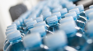 Beverages Bottled products in a manufacturing plant on a conveyer belt